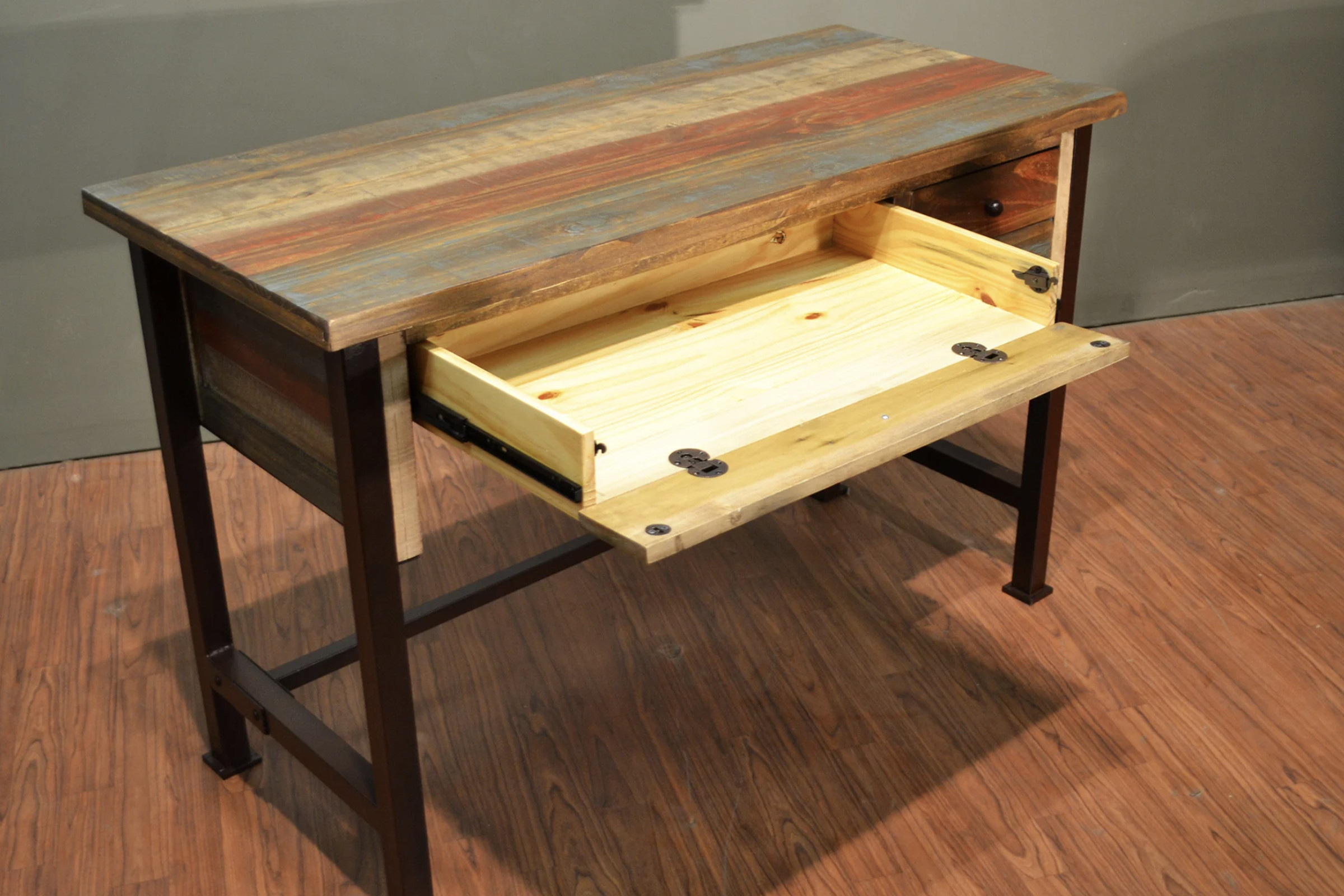 Wooden desk with open drawer.