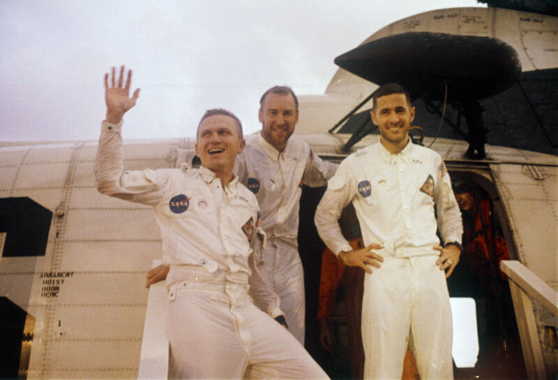 NASA astronauts Frank Borman, Jim Lovell, and Bill Anders wave to onlookers aboard the USS <em>Yorktown</em> after splashdown to end the Apollo 8 mission to the Moon.”><figcaption class=