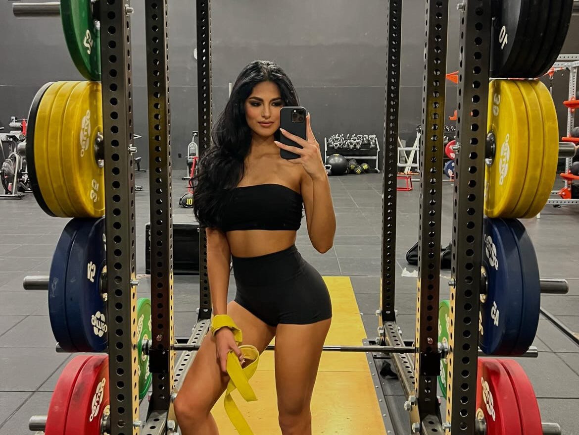 a woman takes a selfie in the gym