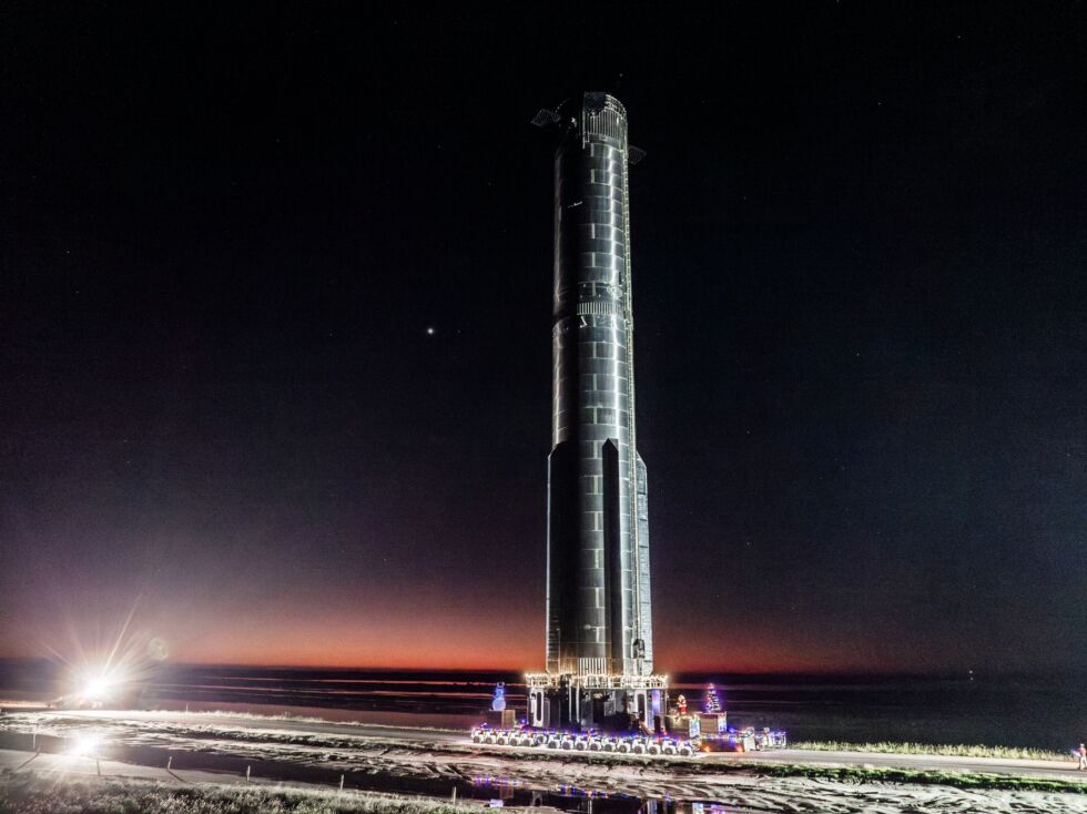 Booster 10, with a few holiday decorations, is rolled to the launch site in South Texas.