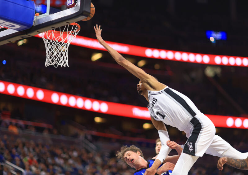 Victor Wembanyama of the San Antonio Spurs drives on Moritz Wagner of the Orlando Magic