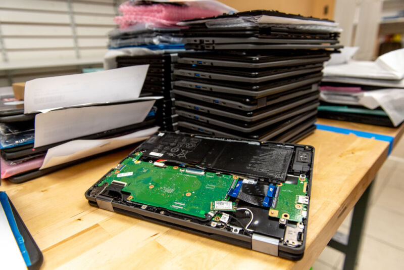 A stack of broken Chromebook laptops