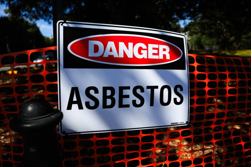  An asbestos warning sign is seen at Victoria Park in Camperdown on February 29, 2024 in Sydney, Australia. 