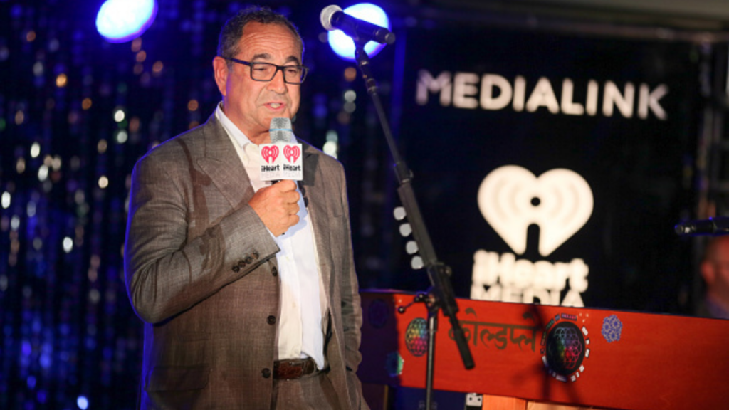 michael kassan holding a microphone on stage