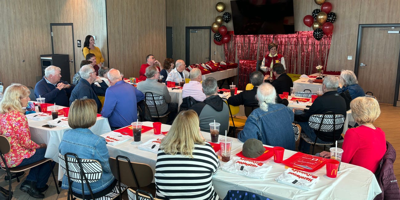 A group of former McDonald's workers gather in a restaurant for a reunion