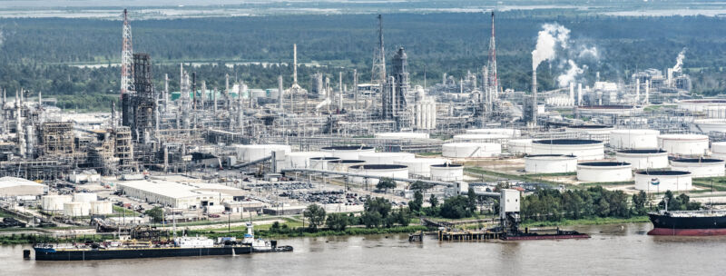 Image of a large industrial facility on the side of a river.