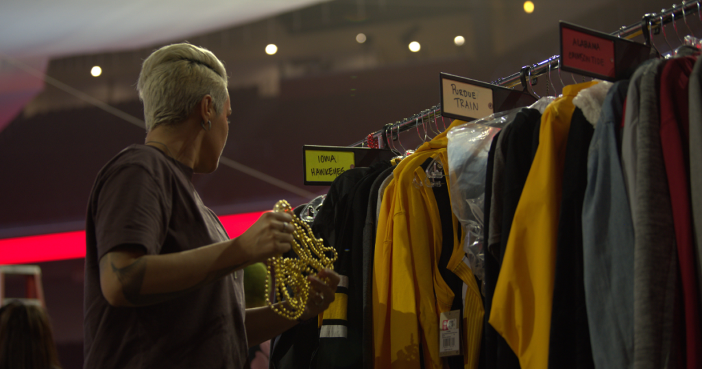 An actor on the set of a Coke Zero Sugar commercial picking out a wardrobe