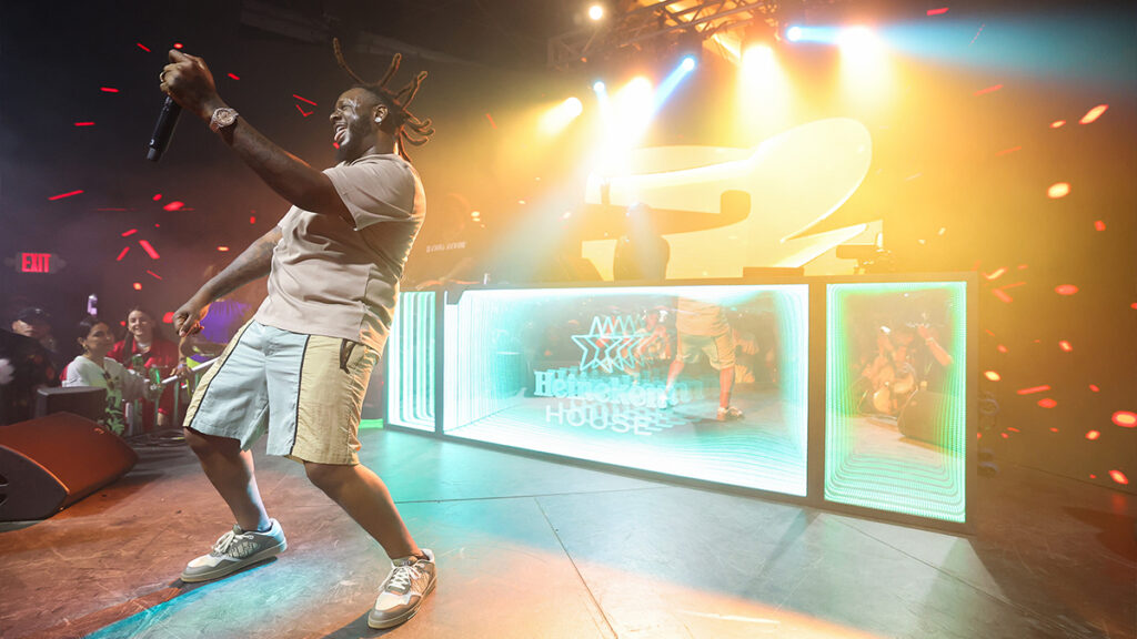 T-Pain performs on a stage with the Heineken logo