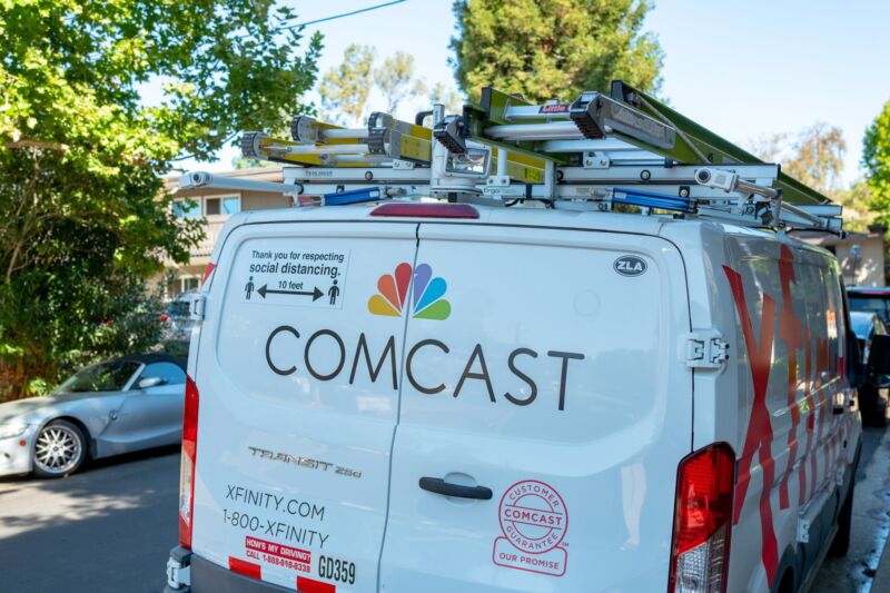 A Comcast service van seen from behind.