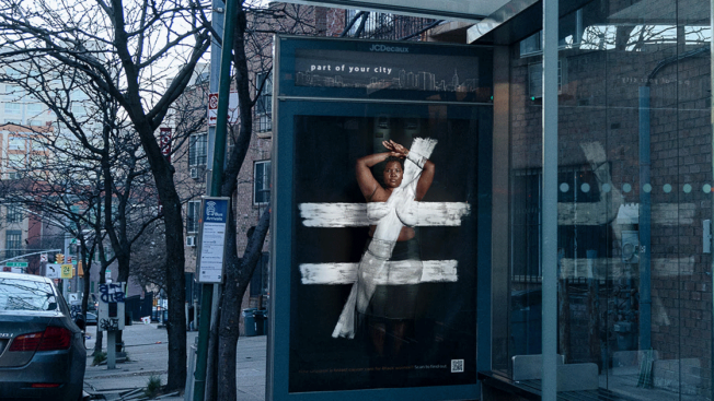 a black woman with white lines painted across her body