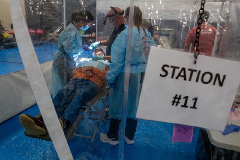 Dental students, working as volunteers, attend to patients at a Remote Area Medical (RAM) mobile dental and medical clinic on October 7, 2023 in Grundy, Virginia. More than a thousand people were expected to seek free dental, medical and vision care at the two-day event in the rural and financially struggling area of western Virginia.