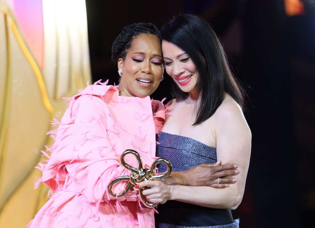 Regina King presents an award to honoree Lucy Liu.