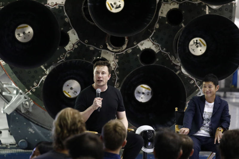 Elon Musk speaks as Yusaku Maezawa, founder and president of Start Today Co., looks on at an event at the SpaceX headquarters in Hawthorne, California, in 2018.