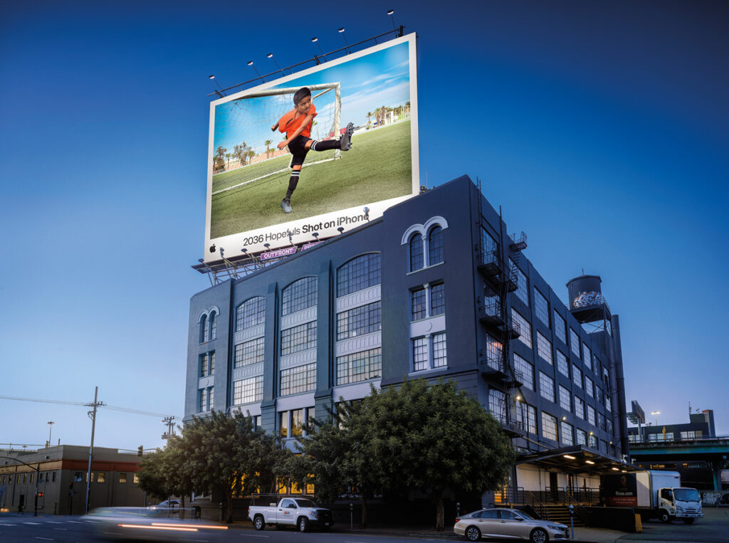 A billboard shows a young soccer player.