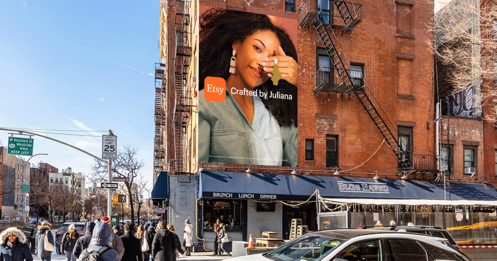 Etsy billboard in new york showing a woman holding an earring