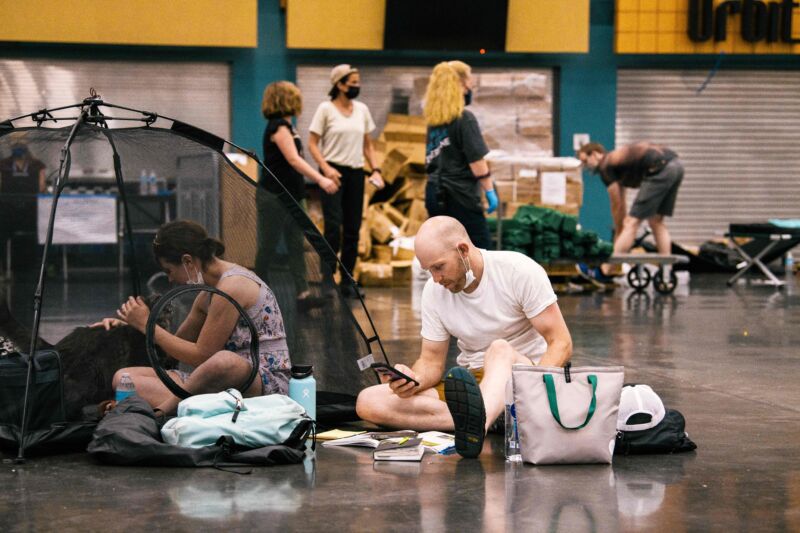 People and their pets rest at the Oregon Convention Center cooling station in Portland as the city is hit with extreme temperatures caused by a heat dome on June 28, 2021