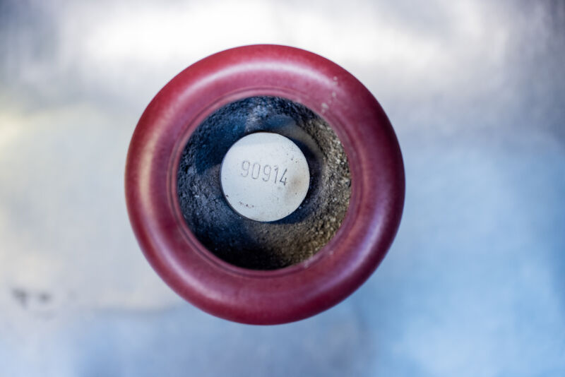 An urn with ashes and a numbered cremation stone that is placed in the coffin of the deceased before the cremation.