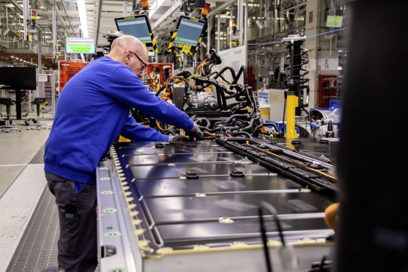 A VW worker assembles an EV battery pack