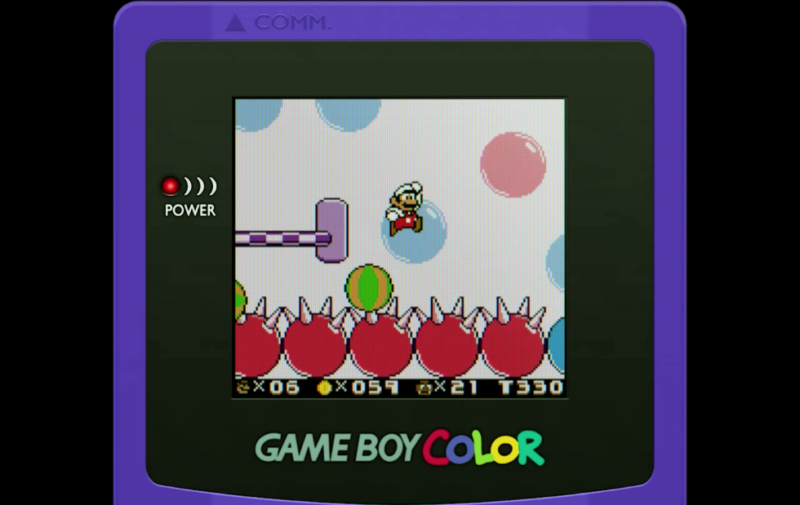 Super Mario Land 2 in full color, with Mario jumping over spiky balls.