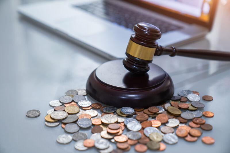 A judge's gavel near a pile of small change.