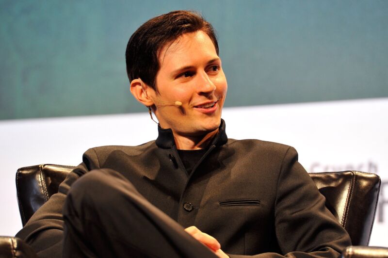 Telegram CEO Pavel Durov sitting on stage and speaking at a conference.