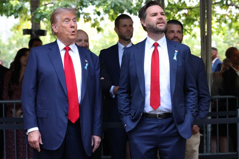 Former US President Donald Trump and Republican vice presidential nominee JD Vance stand next to each other at an outdoors event.