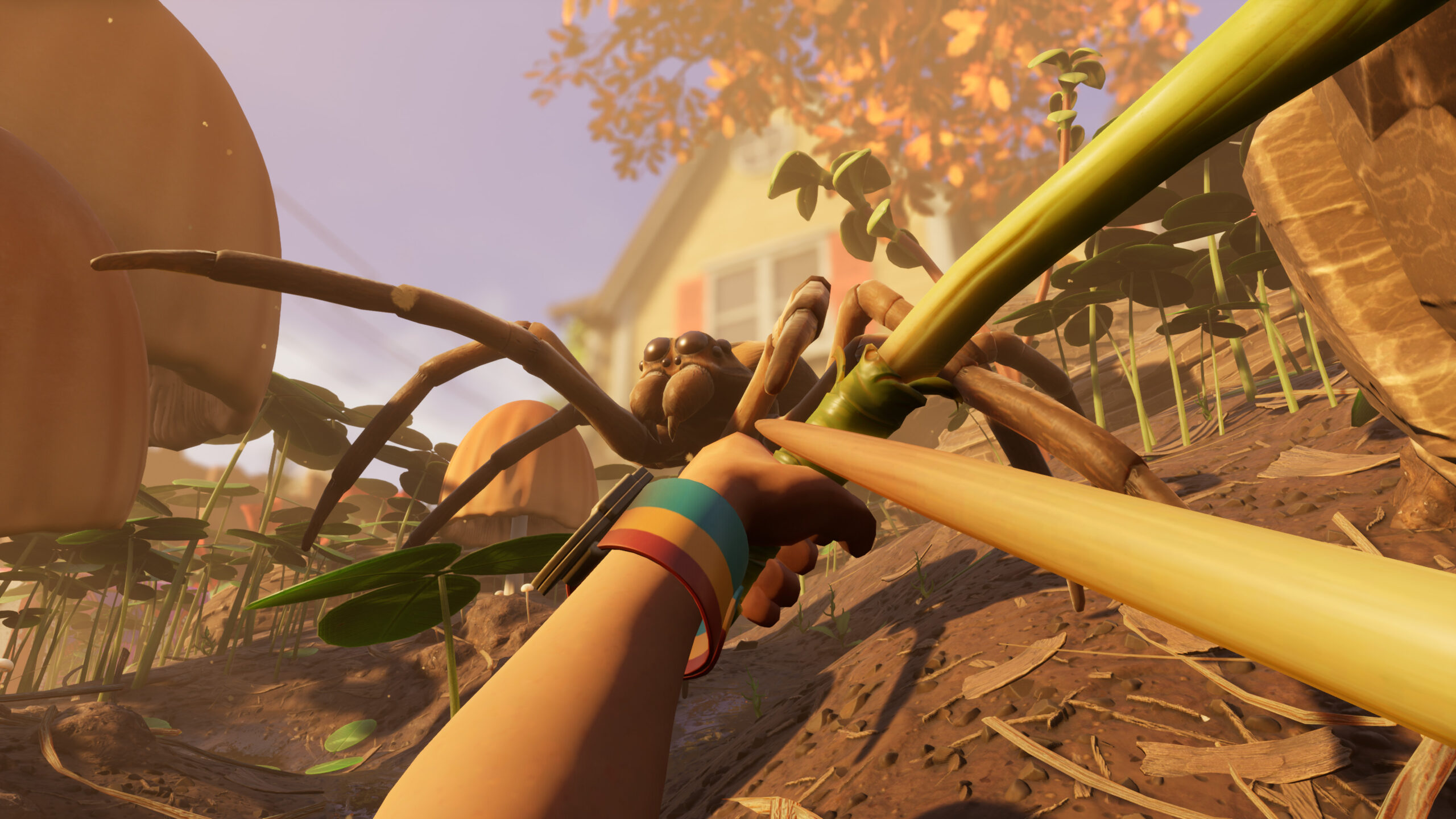 First-person perspective of a suburban house in the background, fall leaves on a tree nearby, and a relatively giant spider approaching the player, who is holding a makeshift bow and arrow, ready to fire.