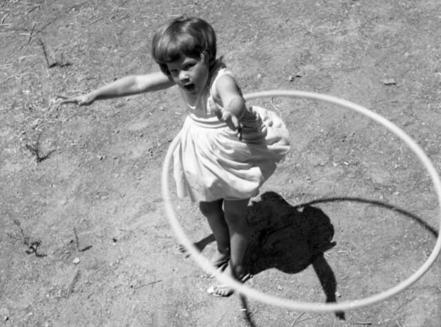 Girl twirling a Hula hoop, 1958