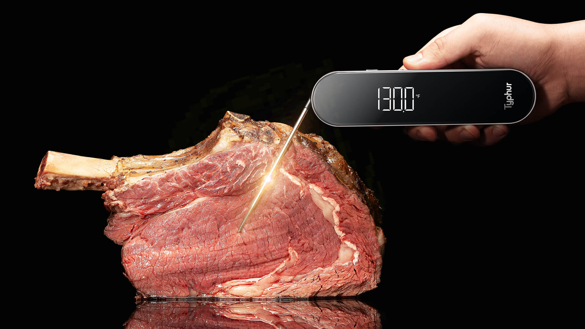 Hand holding instant read thermometer and measured piece of meat.